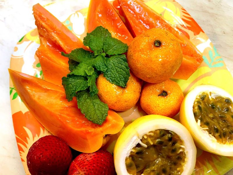 Fresh papaya, tangerines, passion fruit and strawberries with mint